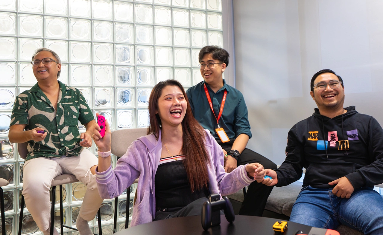 IQI team members playing together in the office