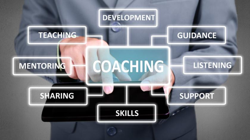 Real estate man with coaching types in front.