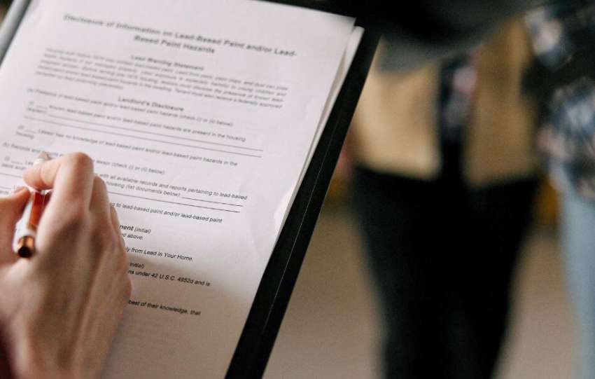 A girl is signing document of sales and leaseback agreement