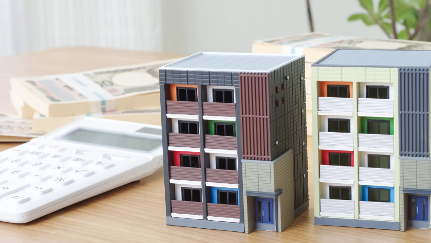 公寓模型，几叠钞票和计算机